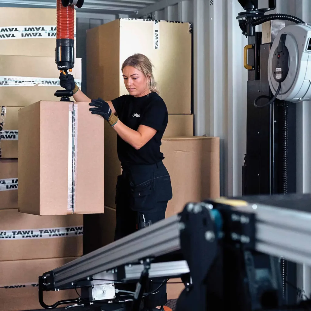 TAWI container unloader untuk proses bongkar muatan cepat dan efisien di gudang